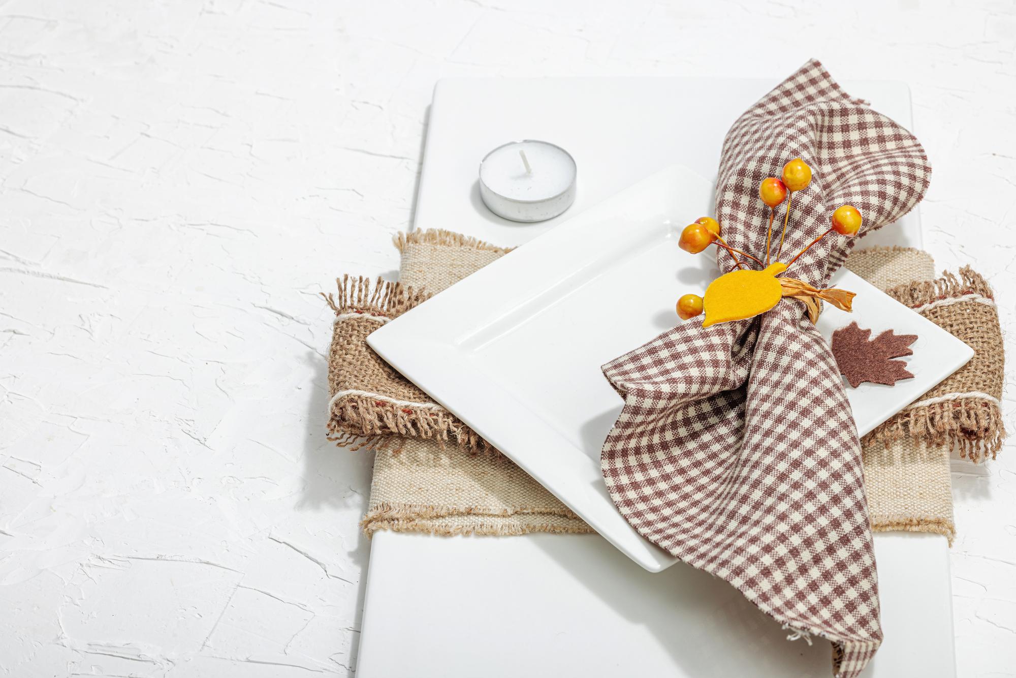 Large embroidered tablecloth spread on wooden table