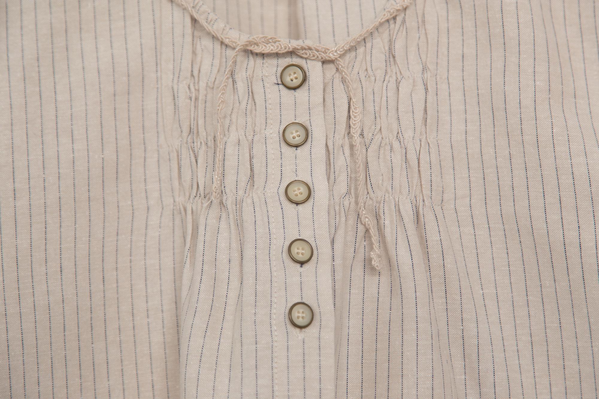 Same shirt with small embroidered motif at cuff